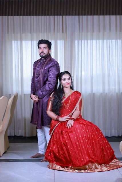 Akhil and Rachana photographed together, she in a red lehenga